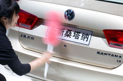 Eine Frau säubert auf der Messe Auto Shanghai das Heck eines Volkswagen Santana. Foto: Volkswagen