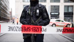 Ein schwer bewaffneter Polizist hinter einem Absperrband in der Züricher Innenstadt (Symbolbild). Foto: Ennio Leanza/KEYSTONE/dpa